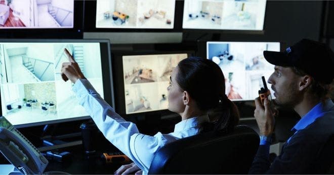 security officer using attention to detail to monitor surveillance footage