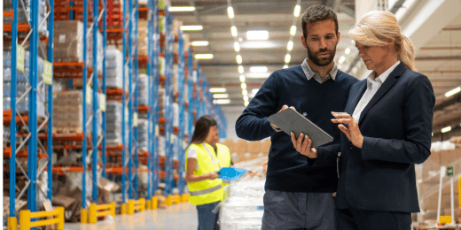 Workers in a warehouse discussing warehouse management best practices