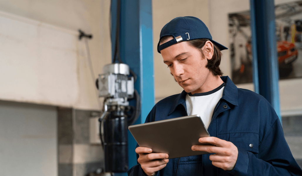 Mechanic using a tablet on a job site