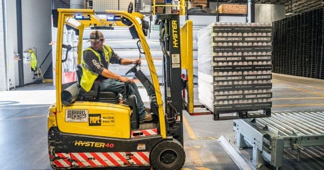warehouse employee using machine
