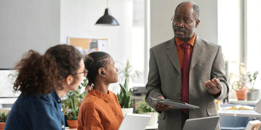 A team huddle on the organization's policy and procedure management process