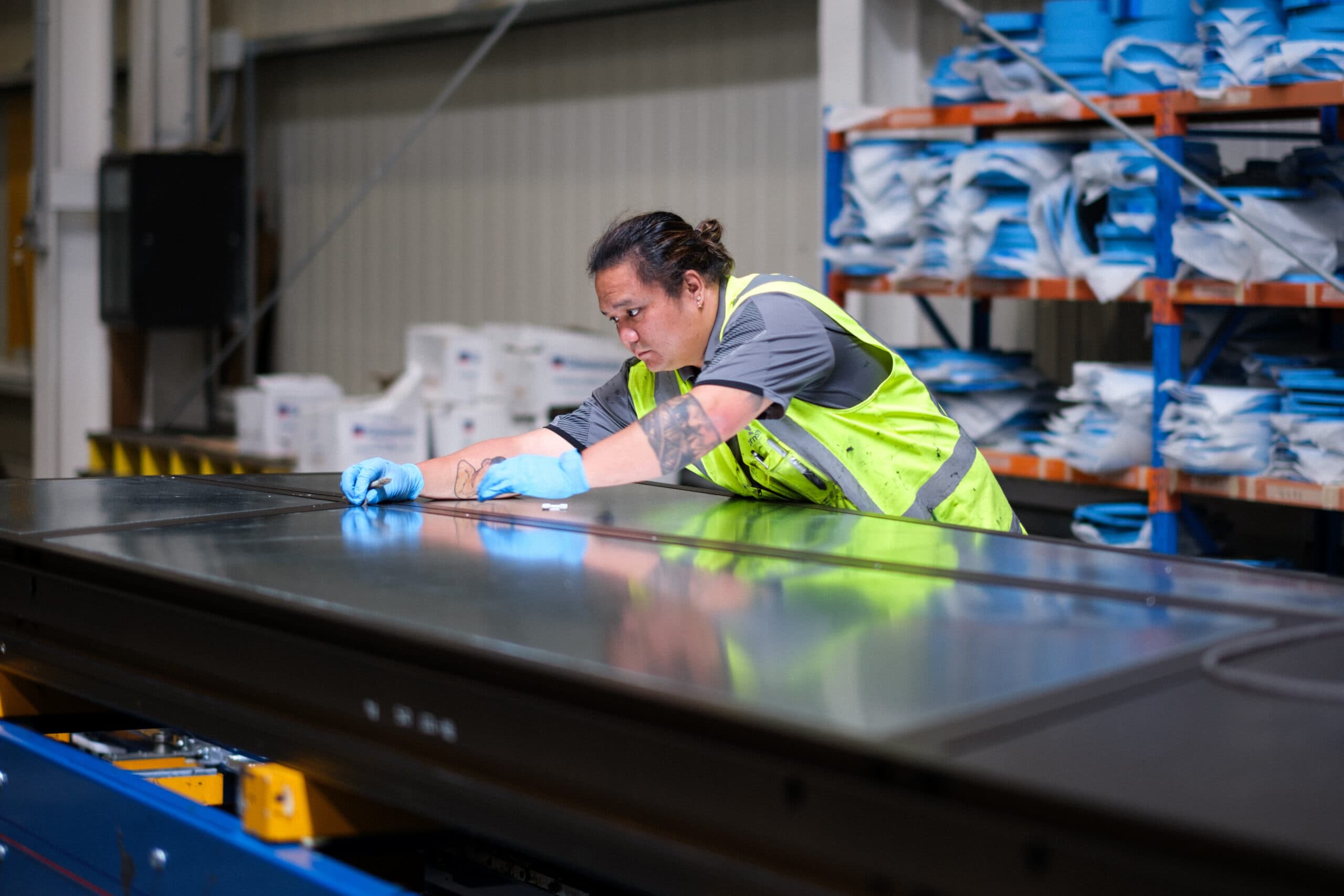 Thermosash Group worker installing bespoke building envelope | Image included in SafetyCulture manufacturing, construction, and installation case study