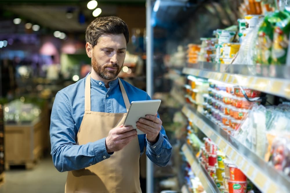 A retail manager doing inspections using retail demand planning software