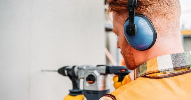 A man using a PPE to reduce occupational noise exposure
