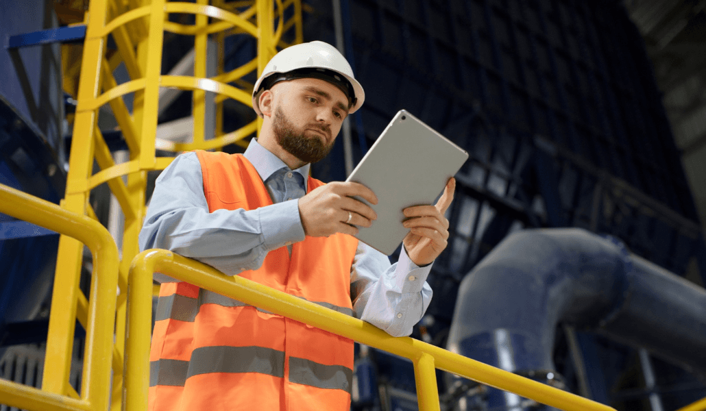 Floor manager inspecting a worksite on his tablet.