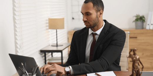 Male lawyer in his office typing on a laptop