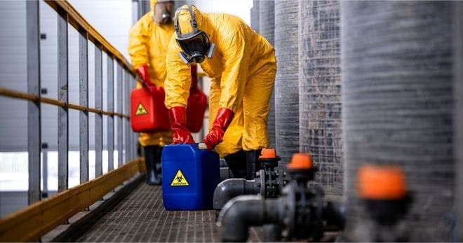 employees practicing proper handling of hazardous materials