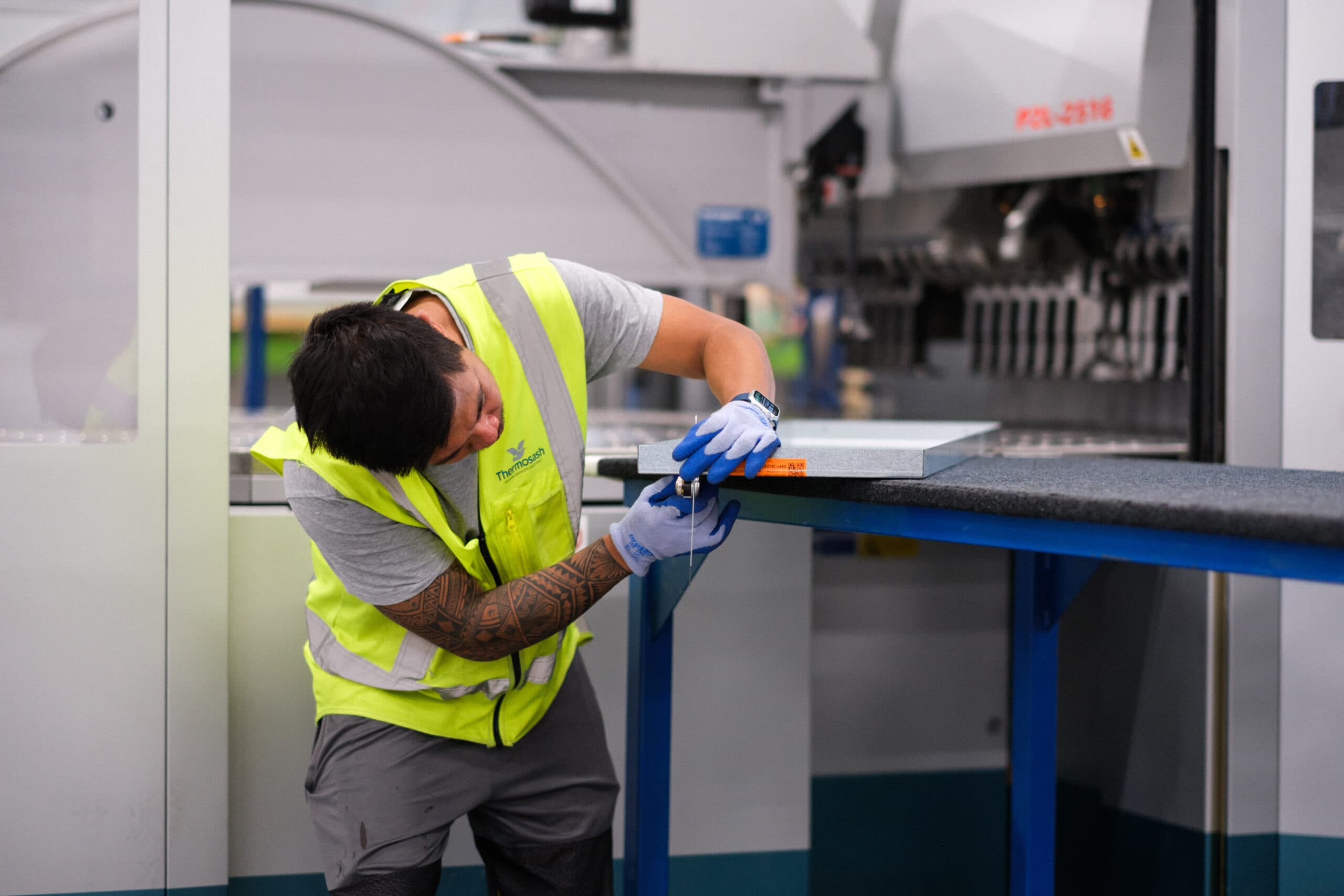 Thermosash Group manufacturing worker creating panels for bespoke building envelope | Image included in SafetyCulture manufacturing, construction, and installation case study