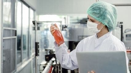 a food safety inspector checking drink quality to comply with codex alimentarius