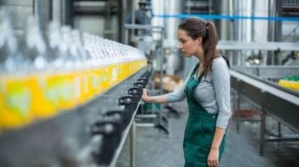 Worker inspecting wastefulness in production