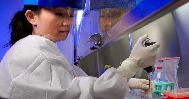 A lab employee handling bloodborne pathogens